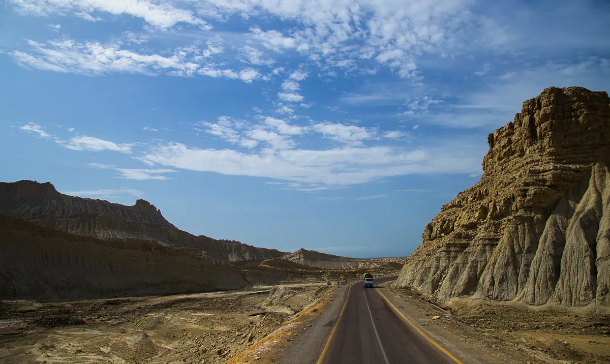 The Makran Coastal Highway curving between eroded desert cliffs in Balochistan